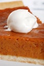 Macro whip cream on pumpkin pie Royalty Free Stock Photo