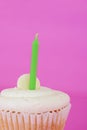 Macro white cupcake with green candle