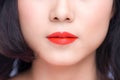 Macro of woman`s face part. Red lips makeup.