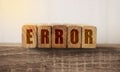 Macro Of The Word Error Formed By Wooden Blocks On A Wooden Table. Medical mistake concept. Mistakes in business startup concept