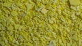 macro yellow sodium sulfide flakes on tapete