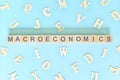 Macroeconomics concept in finance and economics. Word typography on wooden blocks flat lay.