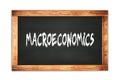 MACROECONOMICS text written on wooden frame school blackboard