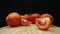 Macrography, slices of tomato placed on board with black background. Comestible. Royalty Free Stock Photo