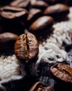 Macrophotography of coffee beans lie on textured wood and burlap. Fresh harvest aromatic coffee. Selective focusing. Royalty Free Stock Photo