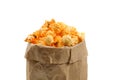 Macrophotography of fresh and warm tasty salt popcorn in a paper package