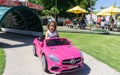 Macy in pink Mercedes battery car