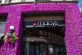 Macy\'s storefront and Stella Trattoria sign with colorful flowers in Manhattan.