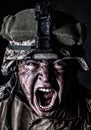 Mad army soldier screaming while looking at camera