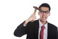 Mad businessman hit his head with hammer Royalty Free Stock Photo