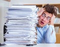 Mad businessman with piles of papers Royalty Free Stock Photo