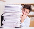 Mad businessman with piles of papers Royalty Free Stock Photo