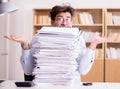 Mad businessman with piles of papers Royalty Free Stock Photo