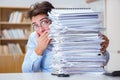 The mad businessman with piles of papers Royalty Free Stock Photo