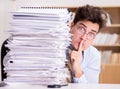 Mad businessman with piles of papers Royalty Free Stock Photo