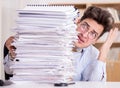 Mad businessman with piles of papers Royalty Free Stock Photo