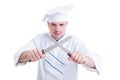 Mad chef or cook holding crossed knifes or blades Royalty Free Stock Photo