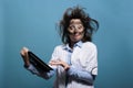 Mad chemist having touchscreen tablet and confused expression Royalty Free Stock Photo