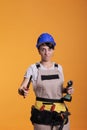 Mad crazy woman contractor posing with renovating tools