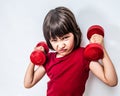 Mad frowning child expressing rage and violence with bully dumbbells