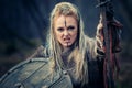 Mad furious viking woman warrior in the attack. Sward and shield. Close-up portrait. Book Cover Royalty Free Stock Photo
