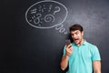 Mad furious young man using smartphone and shouting Royalty Free Stock Photo