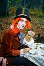 Mad Hatter with a cup of tea in his hand.