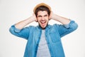 Mad irritated young man covered ears by hands and screaming Royalty Free Stock Photo