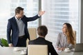 Mad male worker asking female partner leave meeting Royalty Free Stock Photo