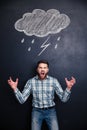 Mad man screaming over blackboard behind him Royalty Free Stock Photo