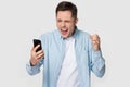 Isolated annoyed Caucasian man scream having cellphone problem Royalty Free Stock Photo