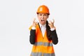 Mad and outraged asian female chief engineer, construction manager burst in rage, losing temper at employees, shouting