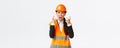 Mad and outraged asian female chief engineer, construction manager burst in rage, losing temper at employees, shouting