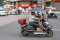 Mad riding in a scooter on busy street in Chongqing