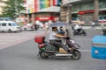 Mad riding in a scooter on busy street in Chongqing