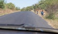 Children begging for water at the side of the road