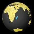 Madagascar on dark globe with yellow world map.