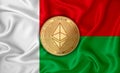 Madagascar flag ethereum gold coin on flag background. The concept of blockchain bitcoin currency decentralization in the