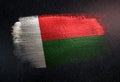 Madagascar Flag Made of Metallic Brush Paint on Grunge Dark Wall