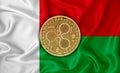 Madagascar flag, ripple gold coin on flag background. The concept of blockchain, bitcoin, currency decentralization in the country