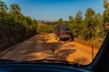 Red dust and mud road in poor condition with large holes Royalty Free Stock Photo