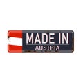 MADE IN AUSTRIA rusted metallic badge with national flag isolated on white background