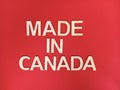 Made in canada sign on a red background Royalty Free Stock Photo