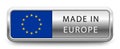 MADE IN EUROPE metallic badge with national flag isolated on a white background.