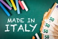 Made in Italy. Euro money and pieces of chalk on a green board Royalty Free Stock Photo