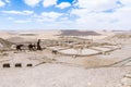 Made of metal silhouettes of a man with donkeys and a dog and winery in ruins of the Nabataean city Avdat, in the Judean desert in