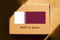 Made in Qatar. Cardboard boxes with text `Made In Qatar` and the Flag of Qatar.