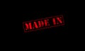 made in rubber stamp red on a black background Royalty Free Stock Photo