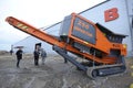 Made in Ukraine stone crusher machine parked in front of the entrance of the hangar