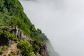 Madeira holiday summer trip vacation tourism mountains sunny day green trees landscape man sit on rock Royalty Free Stock Photo